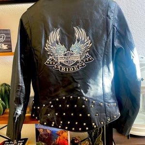 Lady’s black leather HD jacket with brass studs and embroidered eagle.